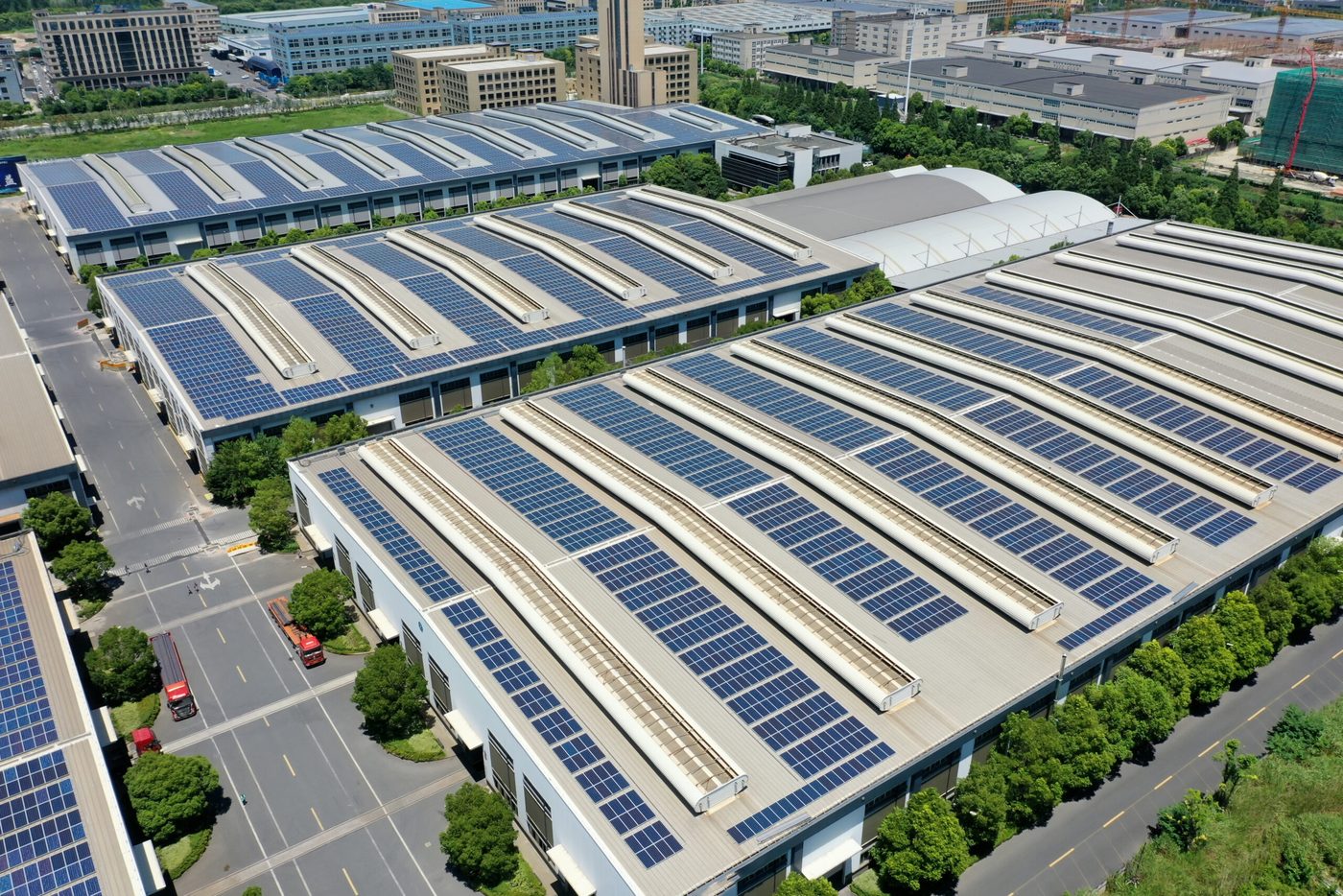 Luftaufnahme von Gewerbehallen mit großflächigen Photovoltaikanlagen